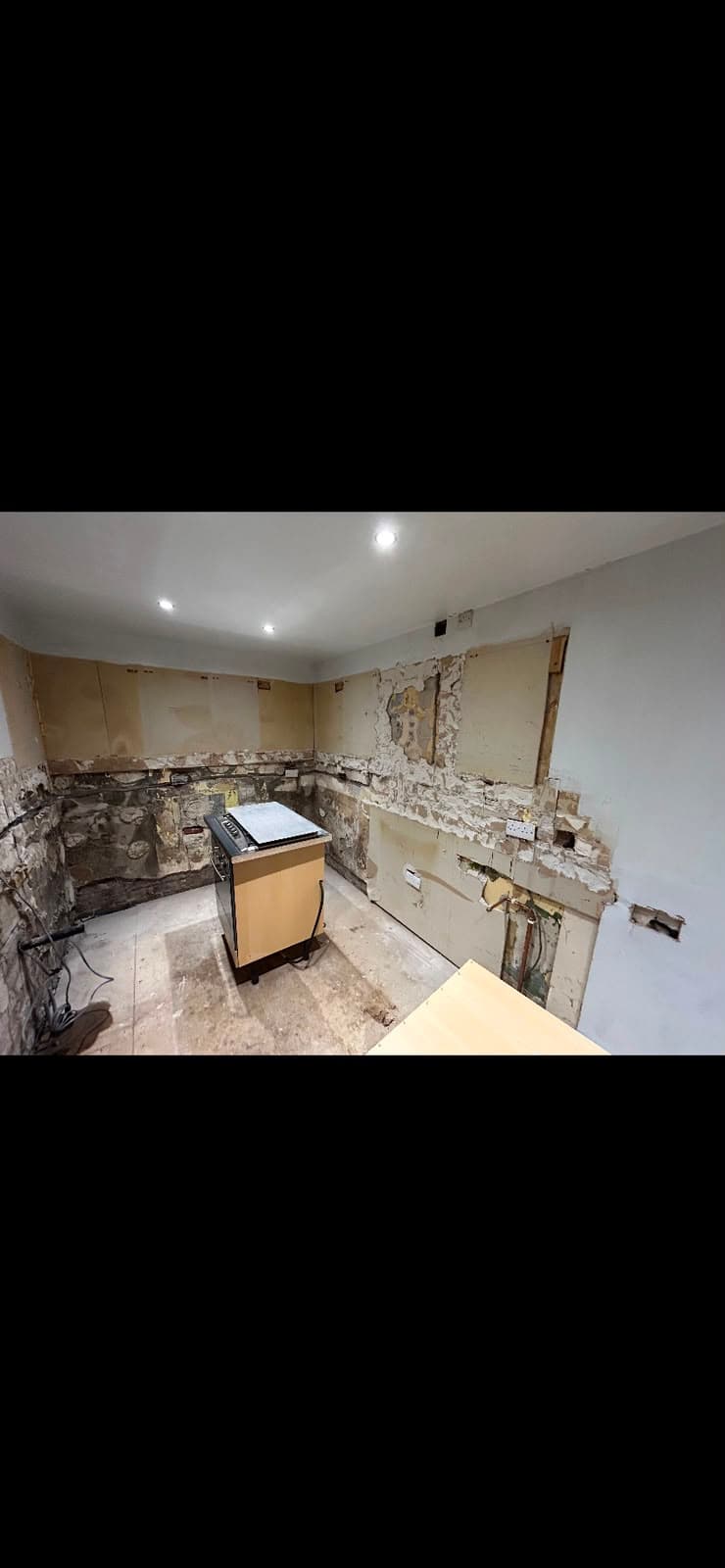 A kitchen stripped back to brick and blockwork ahead of plastering