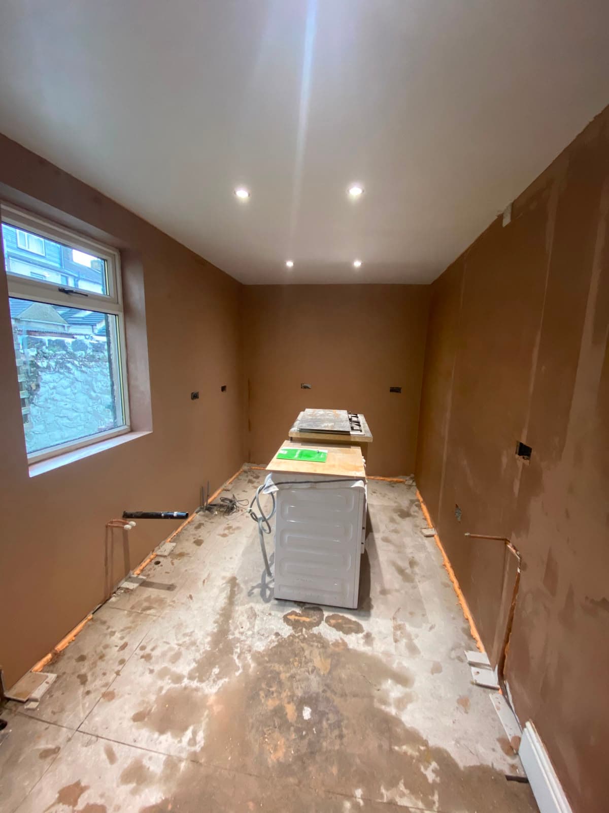 A skimmed kitchen extension with recessed downlights fitted in the ceiling